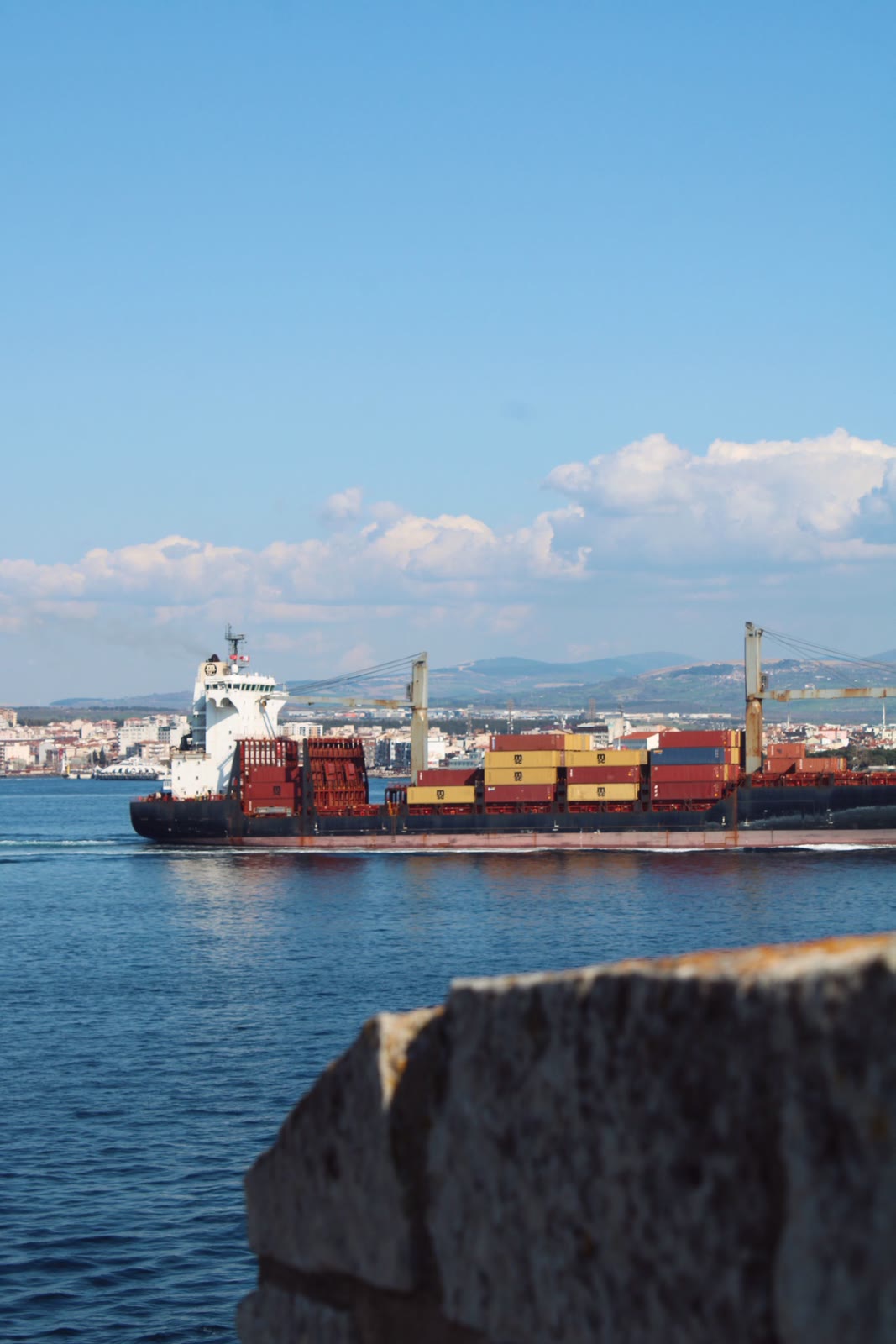 Container ship approaching port — marine supply