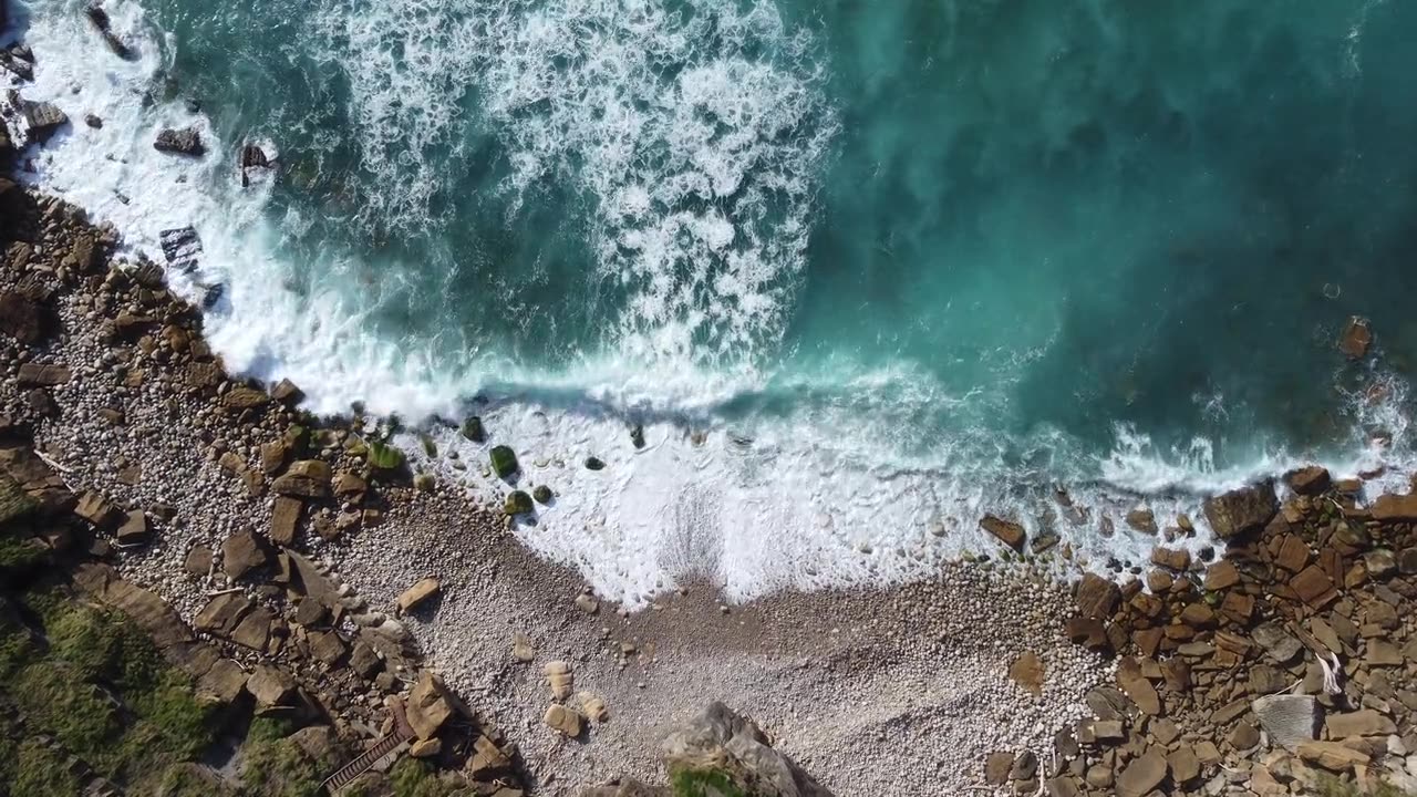 Aerial view of waves breaking on a rocky coastline
